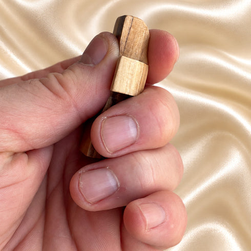 Bethlehem olive wood comfort cross held in a hand to show its size and shape