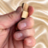 Bethlehem olive wood comfort cross held in a hand to show its size and shape