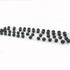 Black lava stone rosary beads on a white background