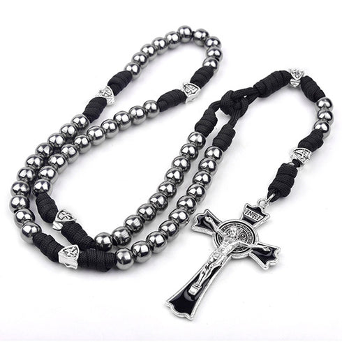 St. Benedict Rosary with silver beads and black paracord on a white background
