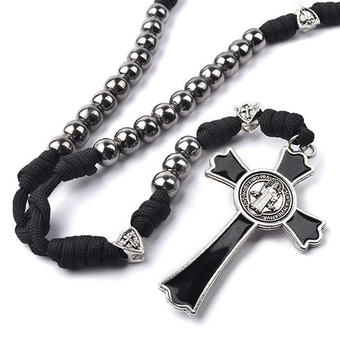 St. Benedict Rosary with silver beads, cross and black cord on a white background