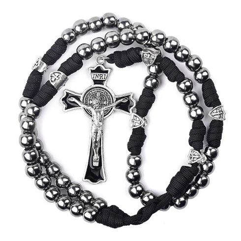 St. Benedict Rosary with silver beads and black cord on a white background