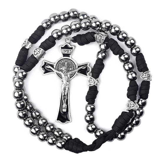 St. Benedict Rosary with silver beads and black cord on a white background