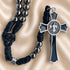 Black and silver rosary with a black braided cord, metallic beads, and a silver-toned crucifix with a black enamel.