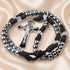 A black and silver rosary with a crucifix, arranged on a beige satin fabric background.