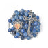 Blue natural stone rosary with a crucifix and heart-shaped medal on a white background