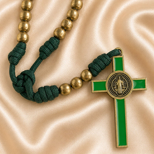 A St Benedict rosary with bronze beads on a green cord, gold-tone crucifix with green enamel.