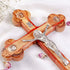 Hand-crafted big olive wood Eastern-style cross with Four Elements, silver crucifix, laid on a white cloth with petals.
