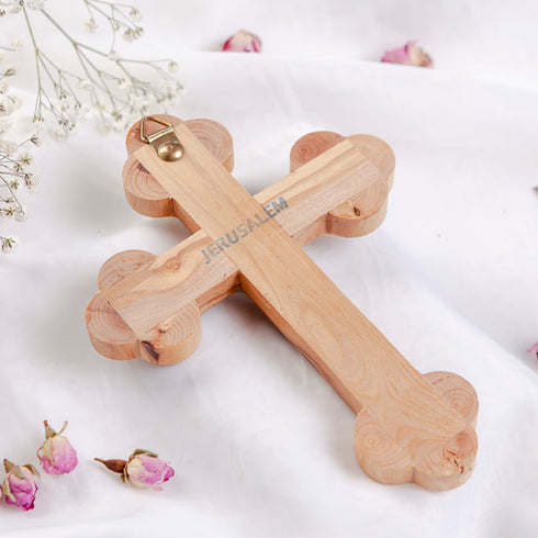 Back of a budded cross with "Jerusalem" written, on white background with flowers around it.