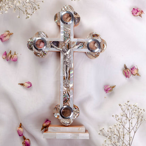 A handmade standing olive wood cross with mother of pearl decor, with Four Elements and a silver-tone crucifixion figure.