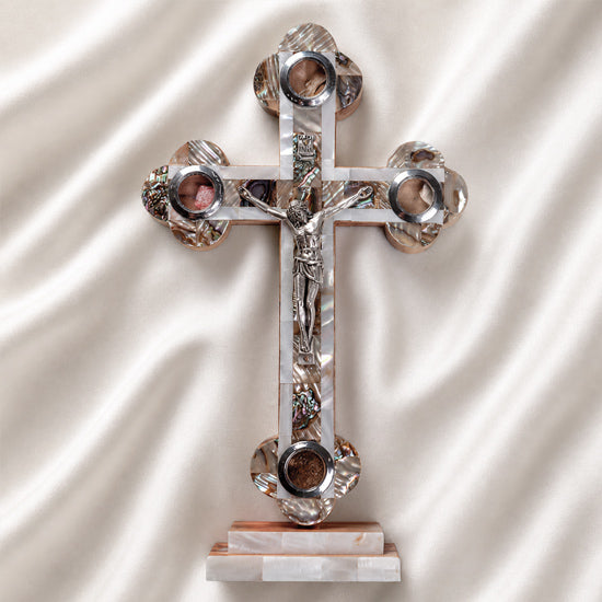 A handmade standing olive wood cross with mother of pearl decor, with Four Elements and a silver-tone crucifixion figure.