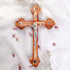 Handmade large olive wood Eastern-style cross with Holy Soil, silver crucifix, photographed on white cloth with rose petals.