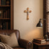 Cozy living room with leather sofa, bookshelf, lamp, and wall cross.