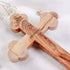 Zoomed image of the back of a handmade olive wood budded cross with 'Jerusalem' written on it and a hook to hang it.