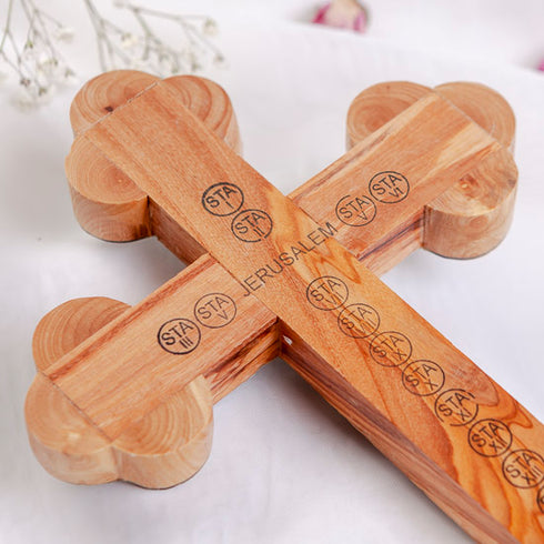 Back of a budded olive wood cross with "Jerusalem" and Stations of Cross written, on white background.