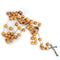 A handmade olive wood rosary with carved beads, Holy Soil and a silver coloured crucifix on a white background.