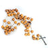 A handmade olive wood rosary with carved beads, Holy Soil and a silver coloured crucifix on a white background.