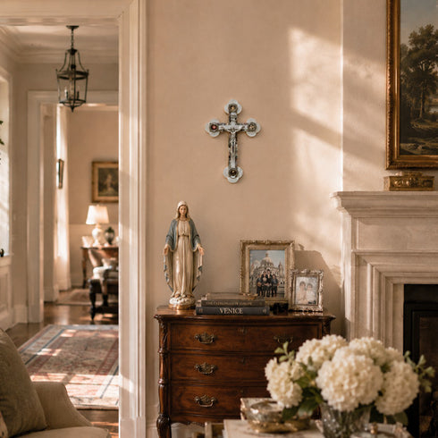 Living room with wooden dresser, religious statue, and framed pictures.