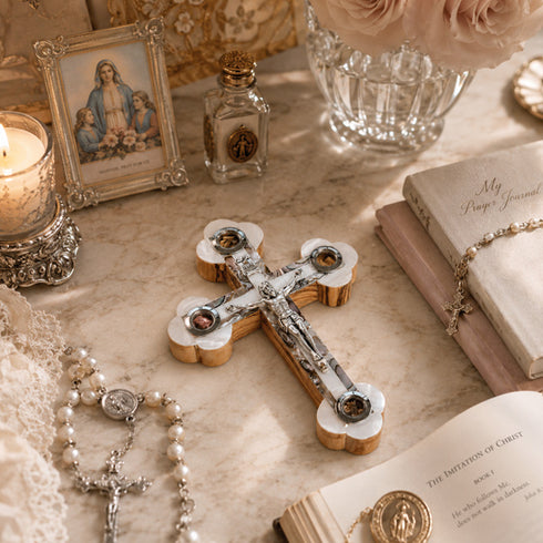 Decorative cross with religious items on a marble surface