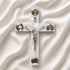 Olive wood Latin cross with crucifix, white Mother of Pearl inlay and Four Elements capsules, on a clean white surface.