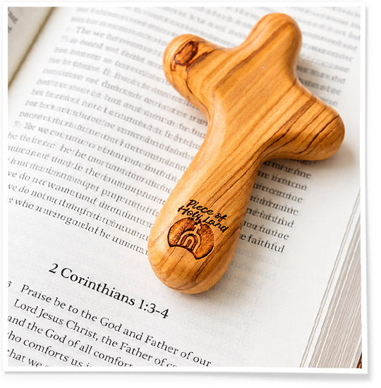 Wooden cross with engraved text on an open book