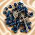 Dark blue crystal rosary, Virgin Mary centerpiece and ornate silver crucifix on champagne satin.
