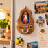 Divine Mercy olive wood holy water font displayed beside a doorway in a warm Christian home interior