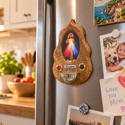Divine Mercy olive wood holy water font displayed on a freezer in a modern kitchen