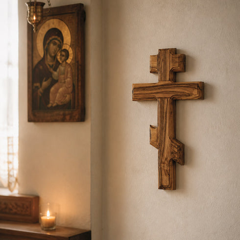 Wooden cross and religious icon on a wall with soft lighting