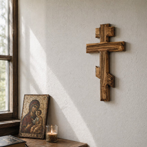 Eastern wooden cross on a wall with an icon bellow