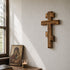 Eastern wooden cross on a wall with an icon bellow