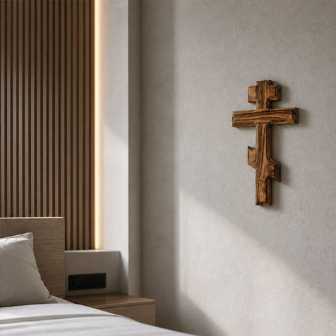 Wooden Eastern cross on a wall in a bedroom setting