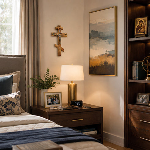 Neatly arranged bedroom with a bed, nightstand, lamp, and wall decor.
