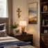 Neatly arranged bedroom with a bed, nightstand, lamp, and wall decor.