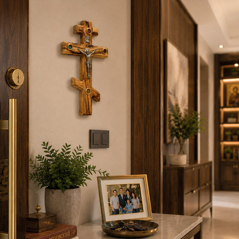 Wooden cross with Jesus Christ figure on a wall in a home setting with decor elements.