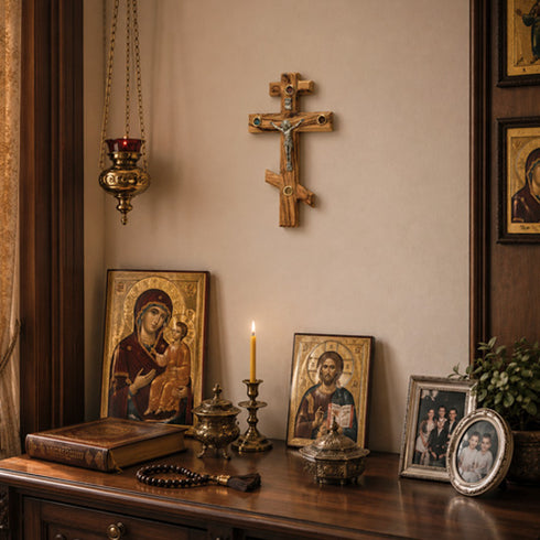 Decorative items including a cross, icons, and candles on a wooden surface.