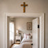 Bedroom with a wooden cross on the wall above the bed