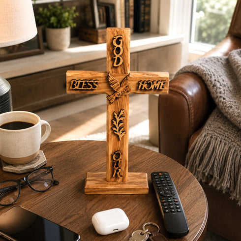 Wooden cross with engraved text on a table in a cozy living room.