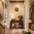 Narrow hallway with wooden floor, white walls, and decorative elements.