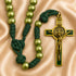 A St Benedict rosary featuring olive green beads on a dark green knotted cord, gold-tone crucifix with green enamel.