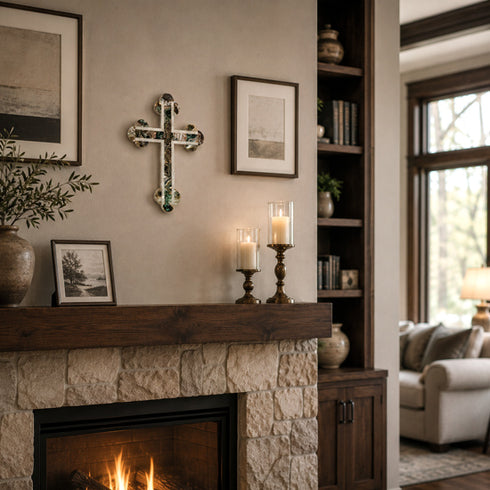 Living room with stone fireplace, candles, and framed pictures.