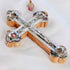 An olive wood crucifix with mother of pearl details and four holy elements, adorned with silver accents.