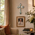 Living room with a cross on the wall, framed picture of the Pope, and a candle.