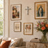 Living room with framed pictures, a cross, and a vase of flowers on a table.