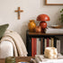 Living room with a bookshelf, lamp, and decor items.