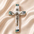 Small olive wood cross with crucifix, Nacre inlay and INRI plaque, laid on white surface.