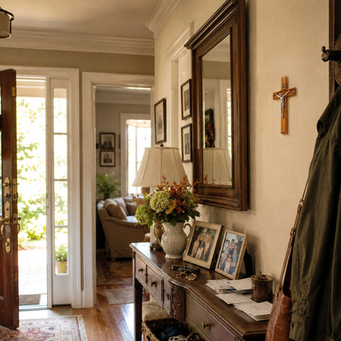Living room with wooden console table, mirror, and decor items.