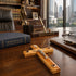 Wooden cross with Jesus Christ figure on a desk with legal books and office supplies.