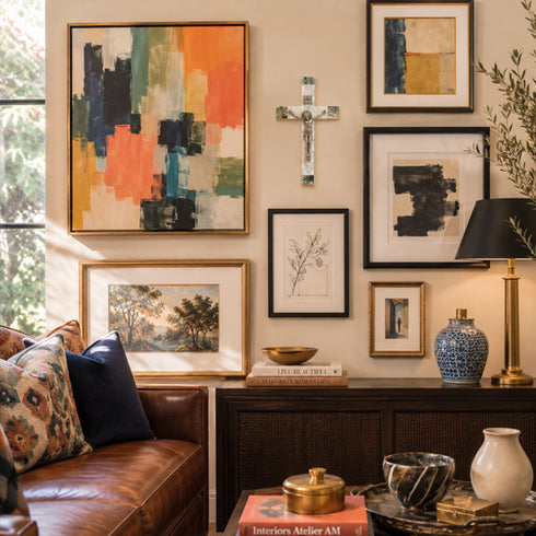Living room with a wall of framed artwork, a cross and decorative items.