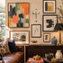 Living room with a wall of framed artwork, a cross and decorative items.